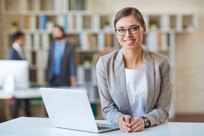 Happy young employee looking at camera